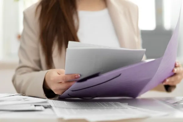 Femme triant des documents au bureau.